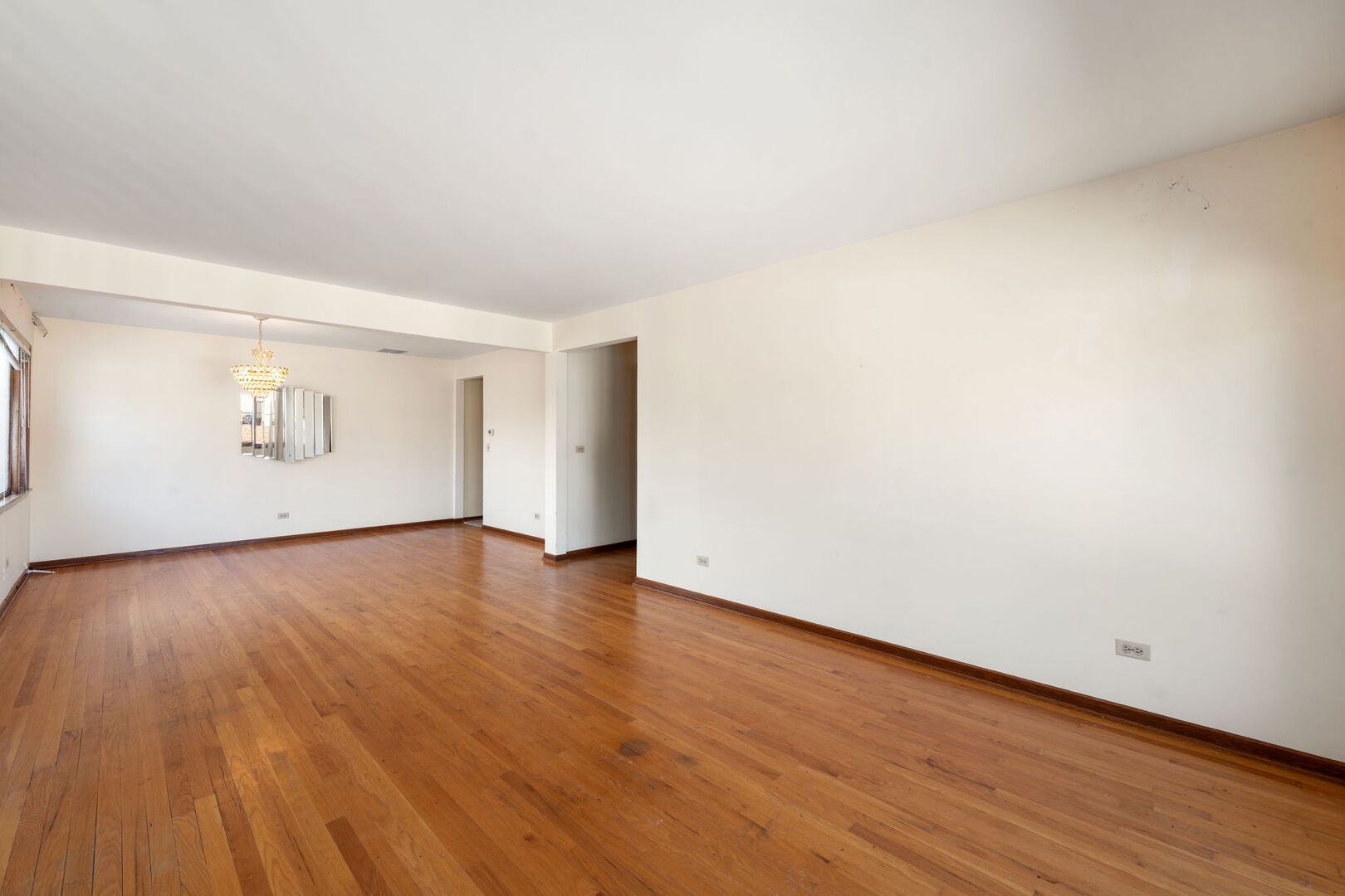 8427 West Windsor Avenue, Unit 2 Chicago, IL 60656 - Photo 5 of 37 an empty room with wooden floor and windows
