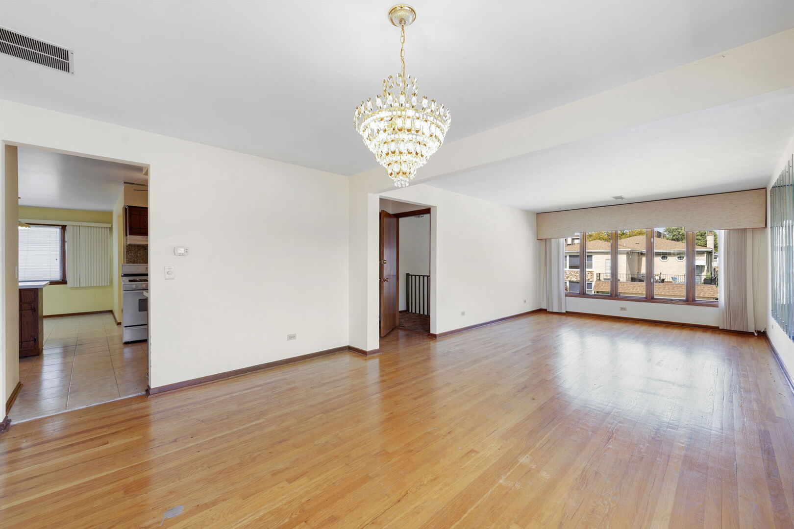 8427 West Windsor Avenue, Unit 2 Chicago, IL 60656 - Photo 7 of 37 a view of an empty room with window and wooden floor