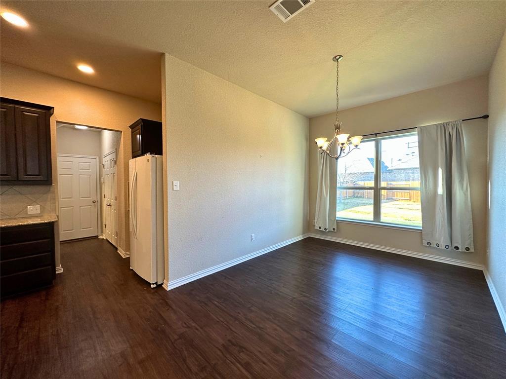 3117 Hidalgo Loop Round Rock, TX 78665 - Photo 11 of 27 a view of a kitchen with wooden floor and a window