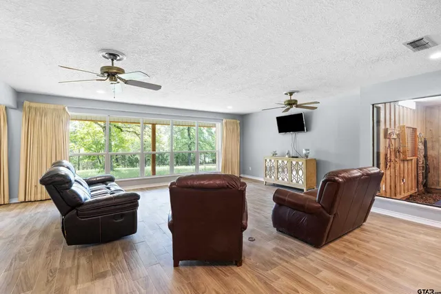 a living room with furniture and a flat screen tv with wooden floor