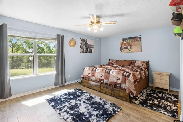 a bedroom with a large bed and a window