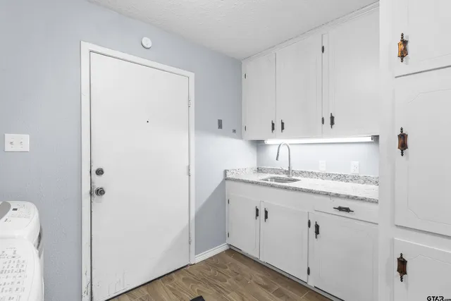 a kitchen with appliances cabinets and a sink