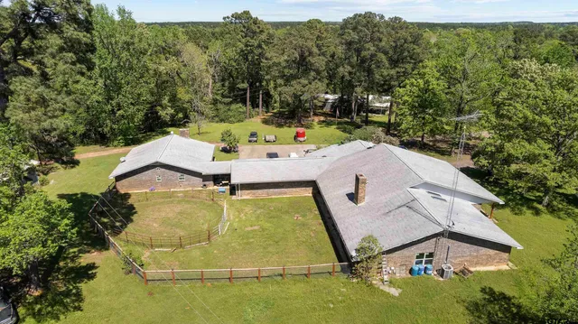 an aerial view of a house with a yard basket ball court and outdoor seating