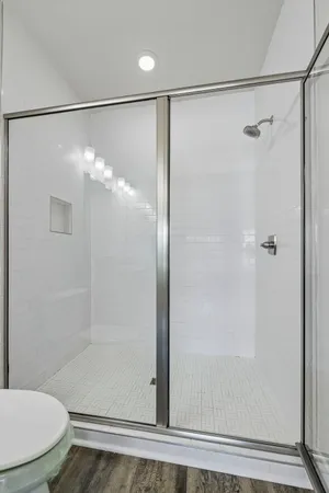 a bathroom with a glass shower door
