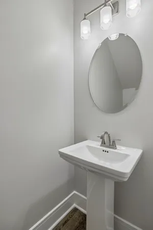 a bathroom with a sink a mirror and vanity