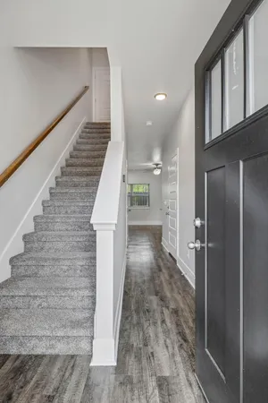 a view of entryway and hall with wooden floor