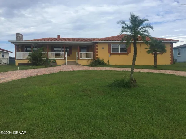 a front view of house with yard and green space