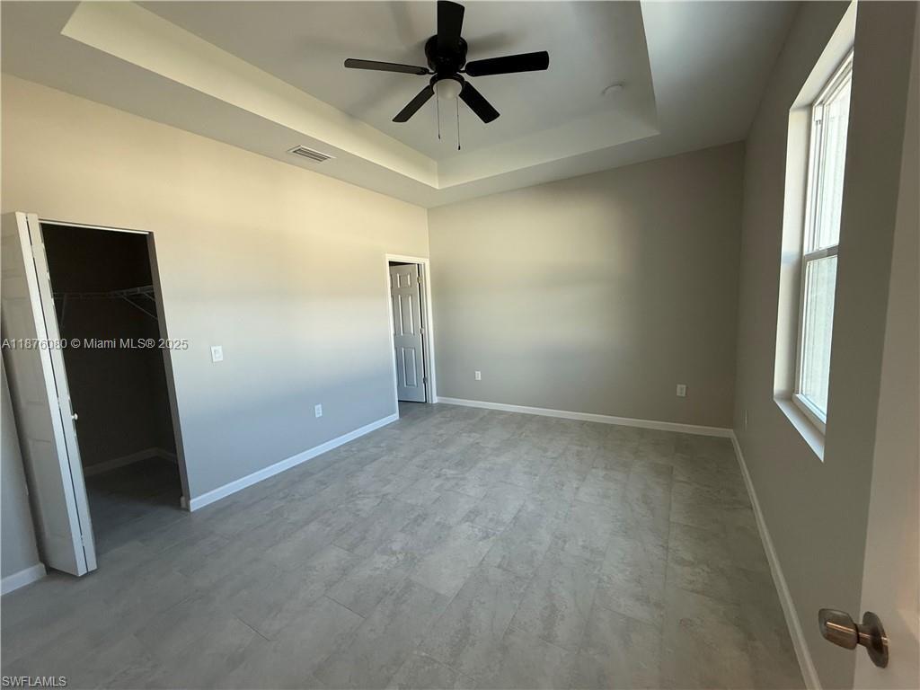 832 Holmes Avenue, Unit 832 Lehigh Acres, FL 33974 - Photo 16 of 24 an empty room with closet and windows