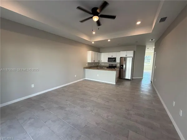 a view of a kitchen with a sink and a stove top oven