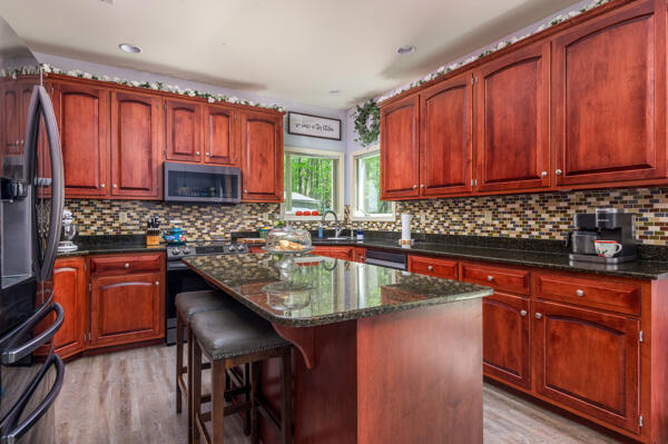 164 Summit Road Swiftwater, PA 18370 - Photo 27 of 42 a kitchen with stainless steel appliances granite countertop wooden cabinets a stove top oven a sink and dishwasher