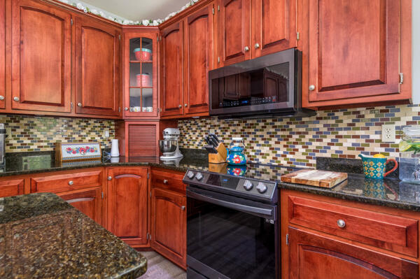 164 Summit Road Swiftwater, PA 18370 - Photo 28 of 42 a kitchen with stainless steel appliances granite countertop a stove a sink and a microwave