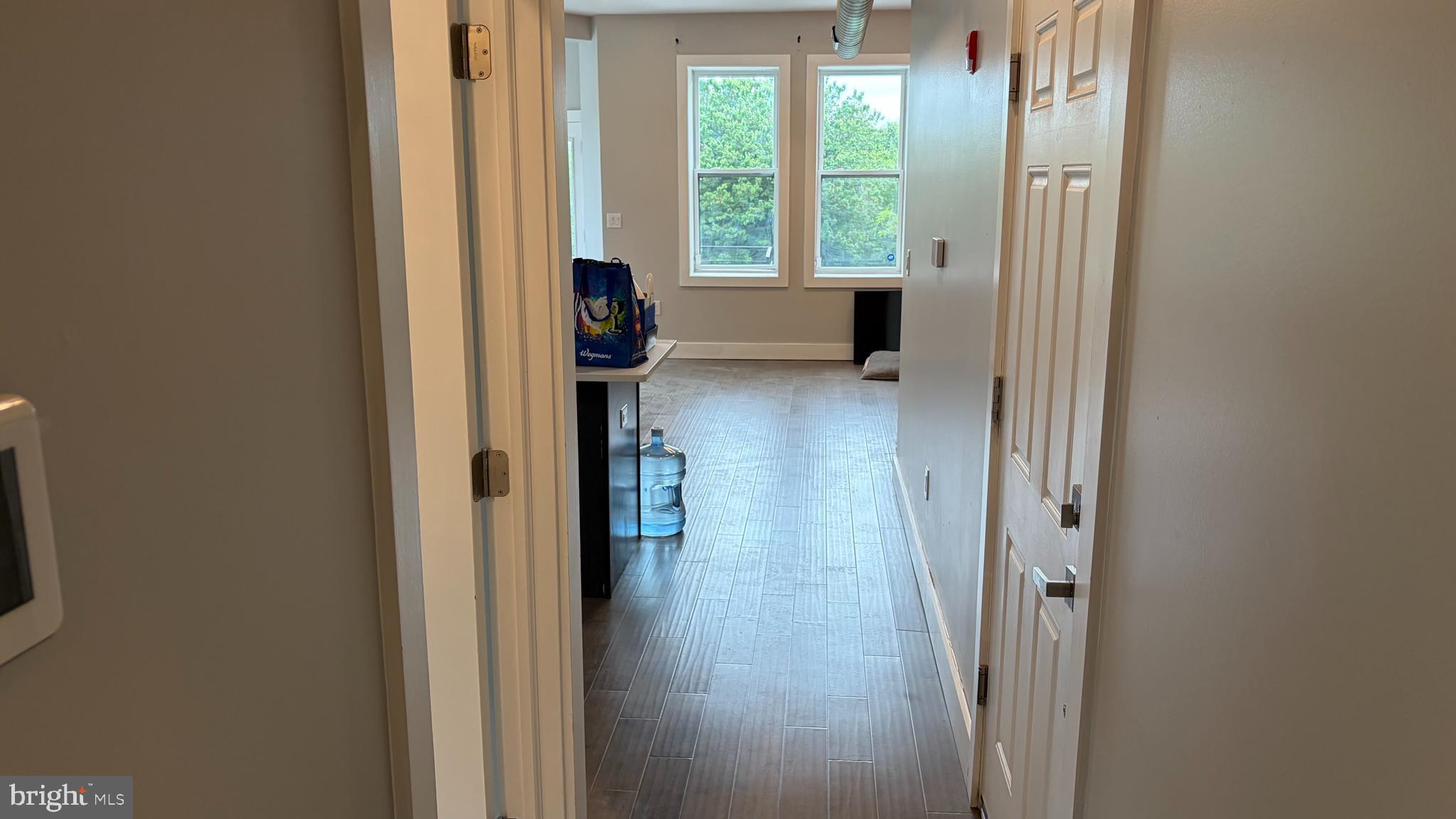 2001 North 33rd Street, Unit 2 Philadelphia, PA 19121 - Photo 11 of 26 a view of a hallway with wooden floor and windows