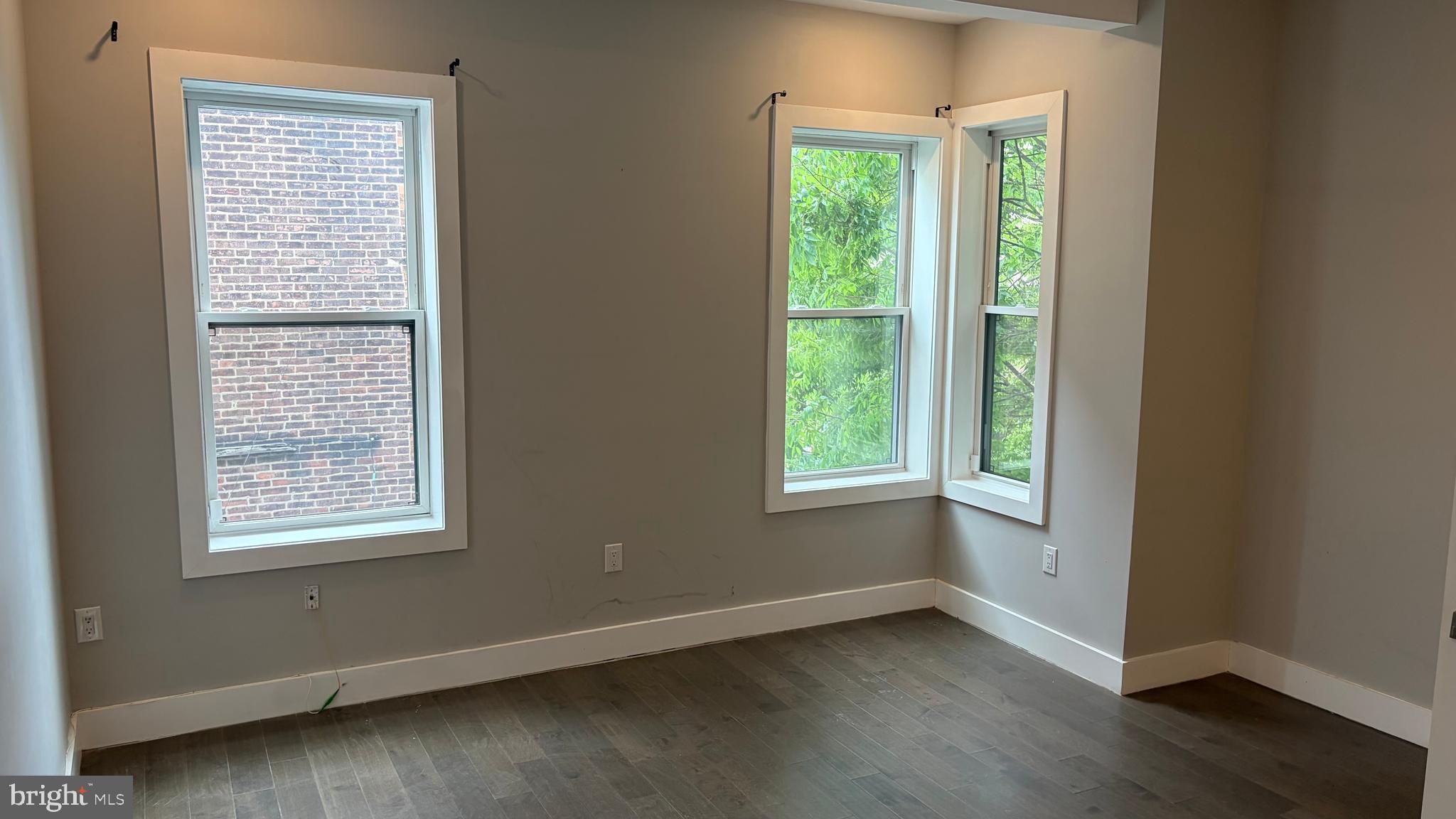 2001 North 33rd Street, Unit 2 Philadelphia, PA 19121 - Photo 21 of 26 a view of an empty room with wooden floor and a window