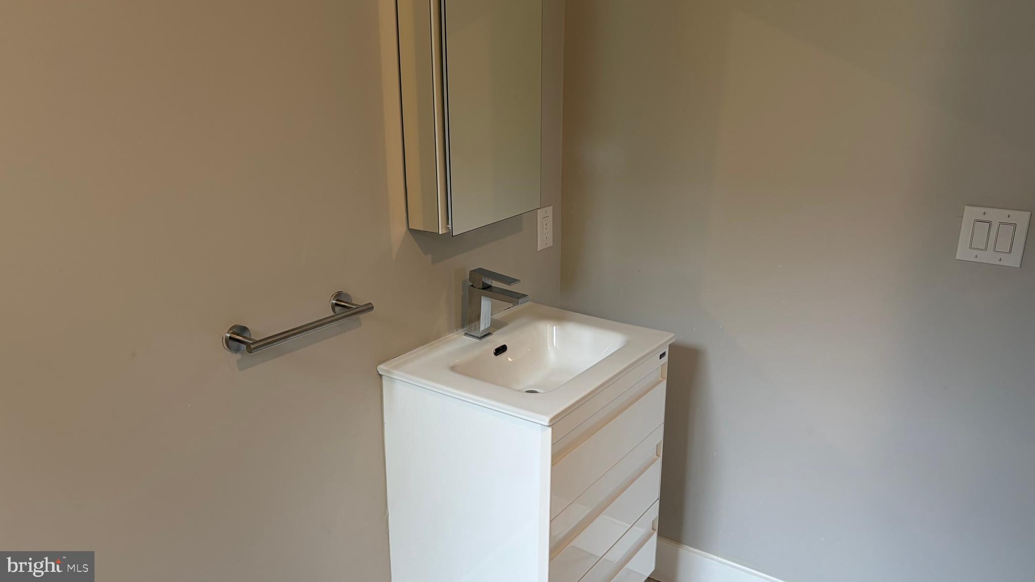 2001 North 33rd Street, Unit 2 Philadelphia, PA 19121 - Photo 24 of 26 a bathroom with a sink and mirror