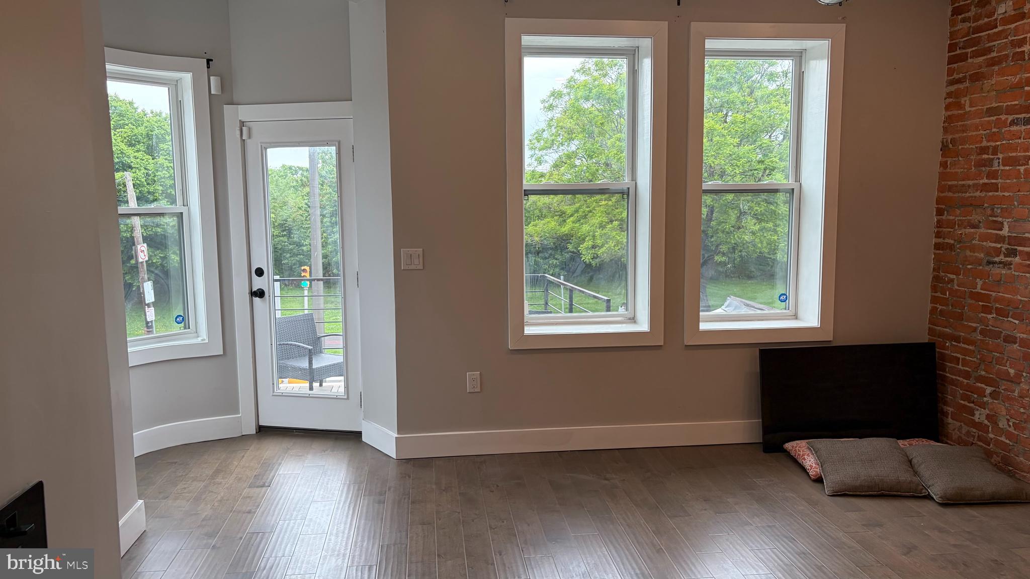 2001 North 33rd Street, Unit 2 Philadelphia, PA 19121 - Photo 3 of 26 an empty room with wooden floor and windows