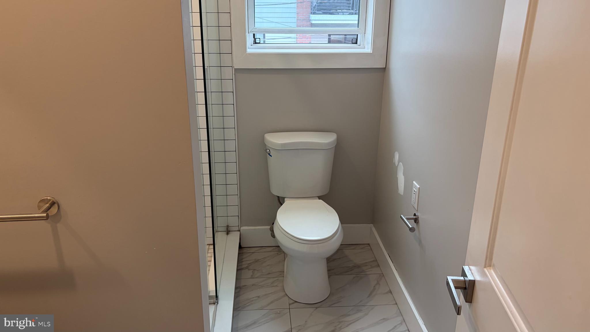 2001 North 33rd Street, Unit 2 Philadelphia, PA 19121 - Photo 10 of 26 a white toilet sitting next to a white sink