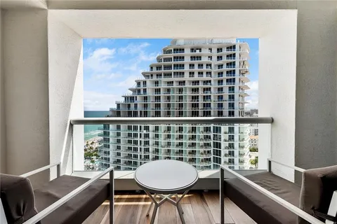 a view of a room with furniture and wooden floor