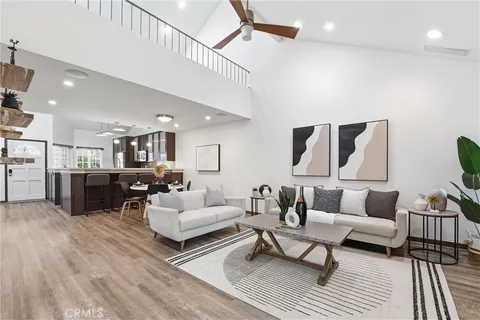 a living room with furniture a rug and white walls