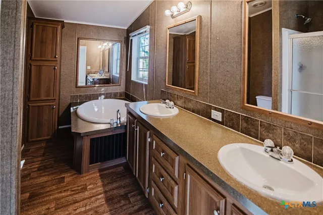a bathroom with a double vanity sink and a mirror