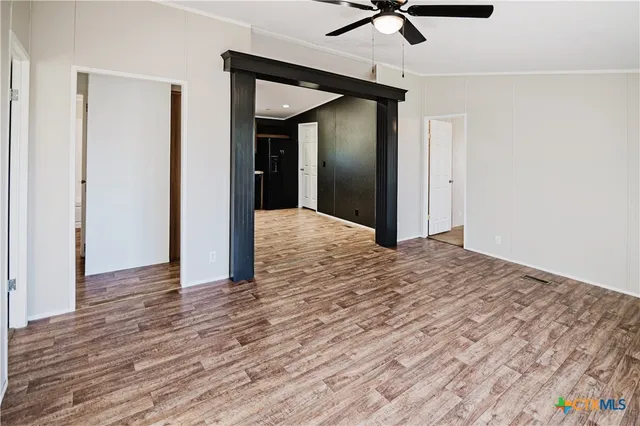a view of empty room with wooden floor
