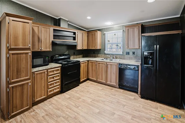 a kitchen with a refrigerator stove and sink