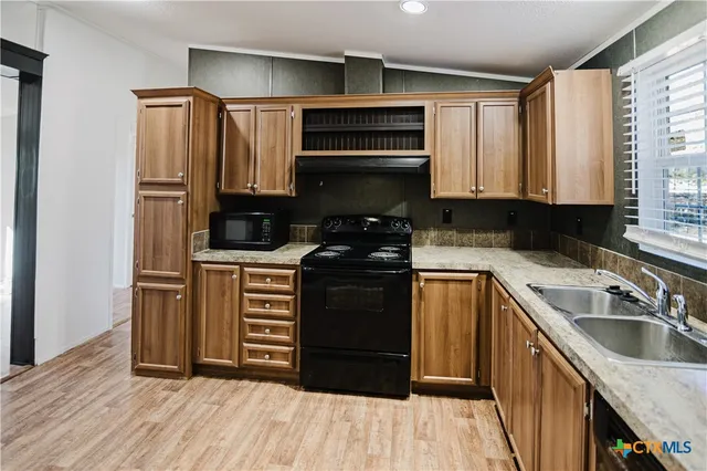 a kitchen with a refrigerator stove and sink