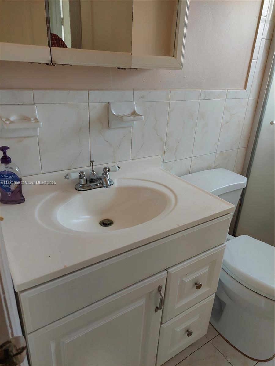 2403 West 76th Street, Unit 203 Hialeah, FL 33016 - Photo 7 of 13 a bathroom with a sink and a toilet