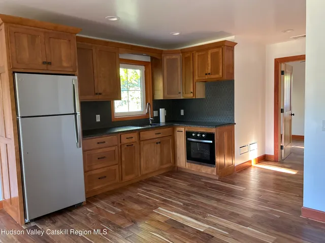 a kitchen with stainless steel appliances granite countertop a refrigerator sink and cabinets