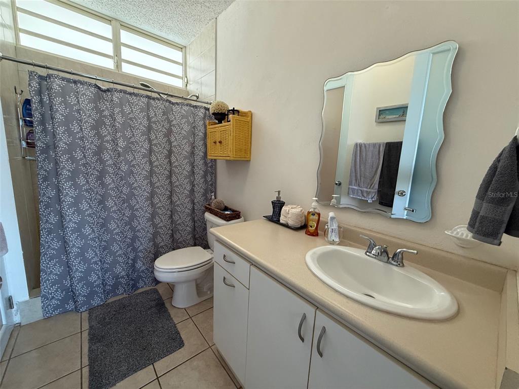 Condo Pelican Reef Condo Pelican Reef, Unit 302 Rincon, PR 00677 - Photo 8 of 16 a bathroom with a sink toilet and shower