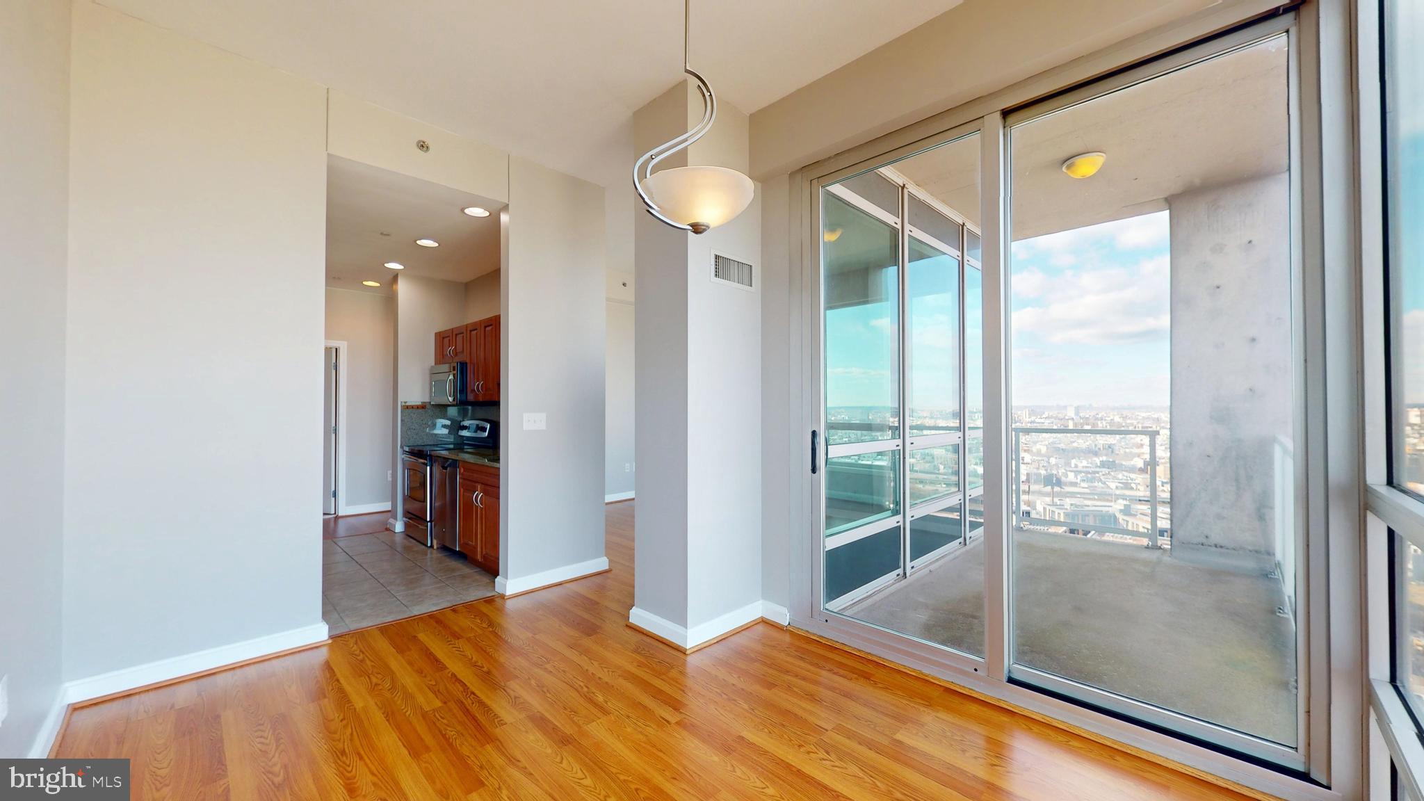 901 North Penn Street, Unit R2404 Philadelphia, PA 19123 - Photo 11 of 29 a bedroom with a bed and a chandelier