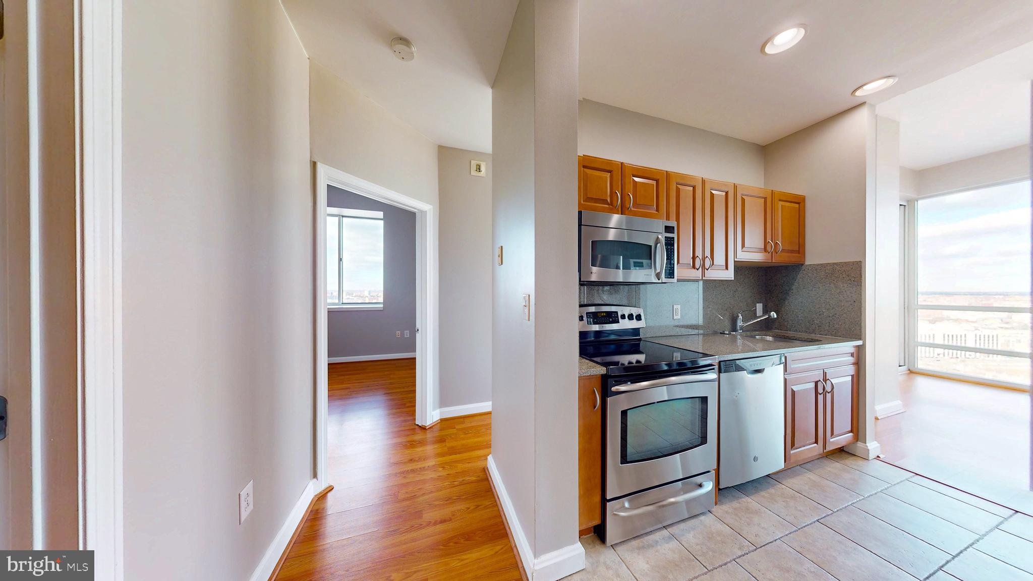 901 North Penn Street, Unit R2404 Philadelphia, PA 19123 - Photo 15 of 29 a kitchen with stainless steel appliances granite countertop a stove and a sink