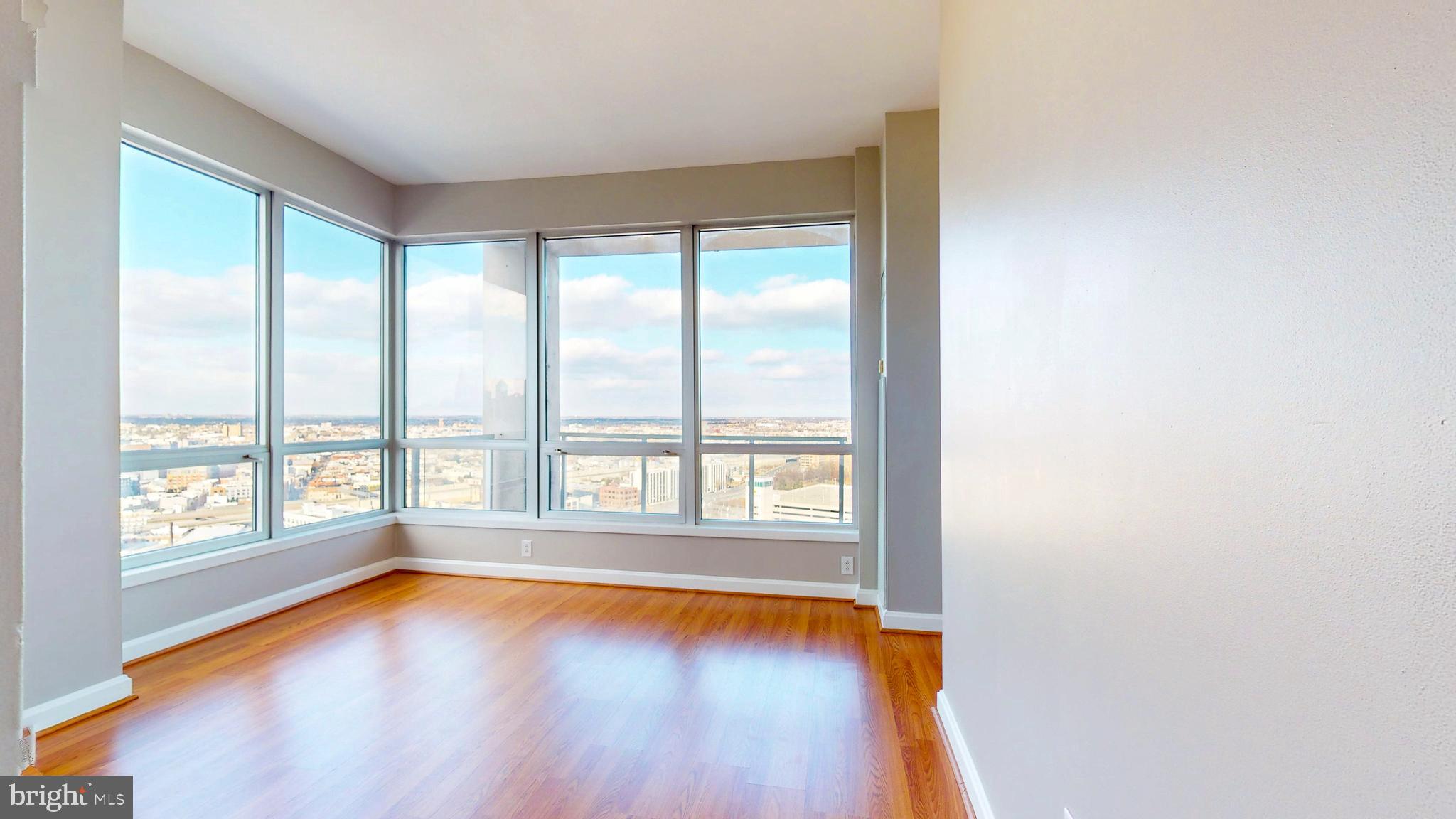 901 North Penn Street, Unit R2404 Philadelphia, PA 19123 - Photo 3 of 29 wooden floor in an empty room with a window