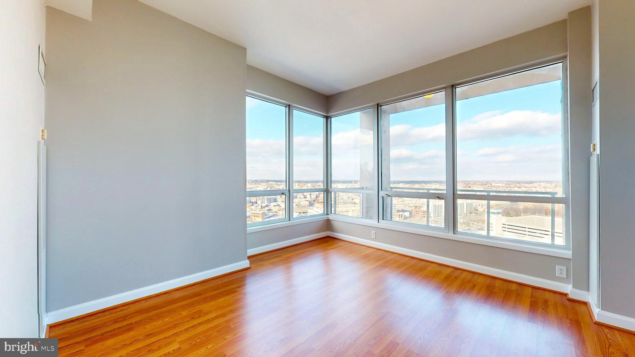 901 North Penn Street, Unit R2404 Philadelphia, PA 19123 - Photo 4 of 29 a view of an empty room with wooden floor and a window