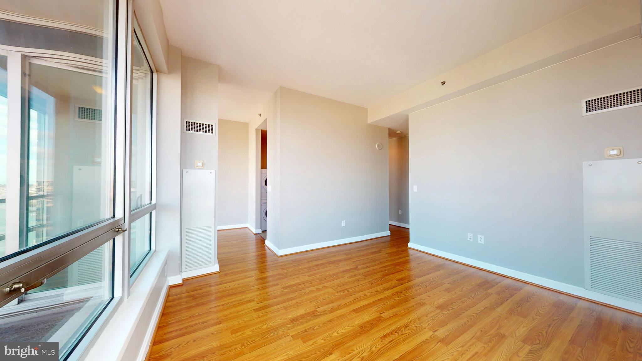 901 North Penn Street, Unit R2404 Philadelphia, PA 19123 - Photo 8 of 29 a view of a bedroom with wooden floor and a window