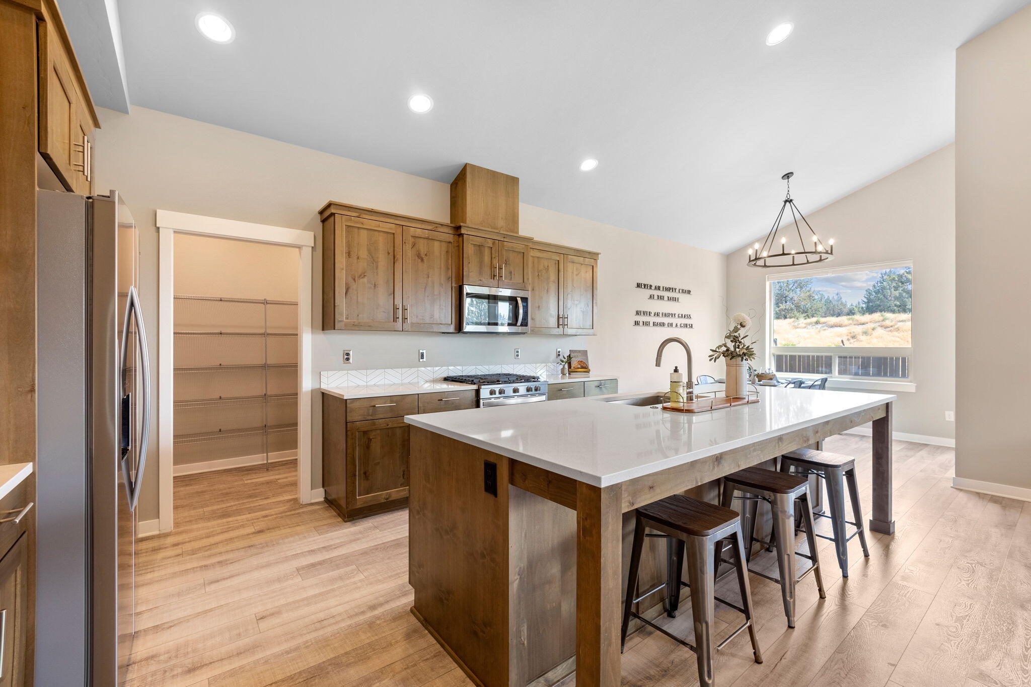 4396 Southwest 36th Street Redmond, OR 97756 - Photo 10 of 36 Kitchen with stainless steel appliances, gas range, and quartz countertops.