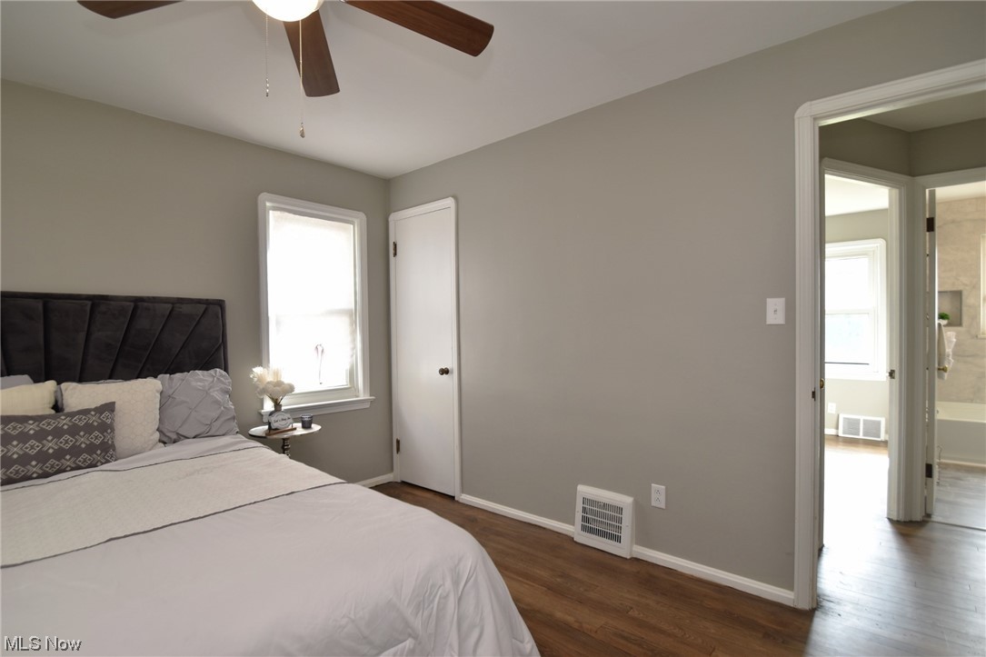 13300 Rockside Road Garfield Heights, OH 44125 - Photo 15 of 32 Bedroom featuring dark hardwood flooring, ceiling fan, and ensuite bath
