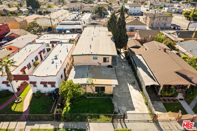 an aerial view of a residential apartment building with a yard