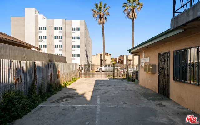 a view of a building with a palm tree in the background