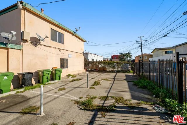 a view of a white house with a yard