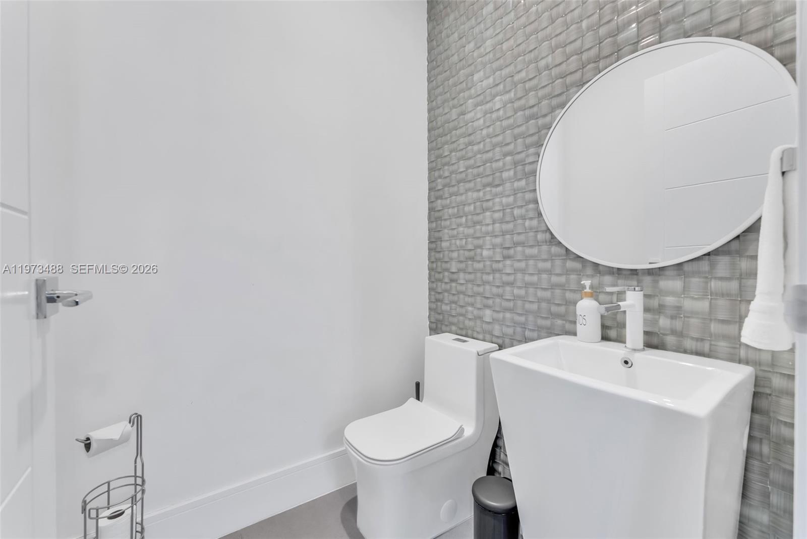 3055 Carter Street, Unit 3055 Miami, FL 33133 - Photo 11 of 32 a bathroom with a toilet sink and mirror