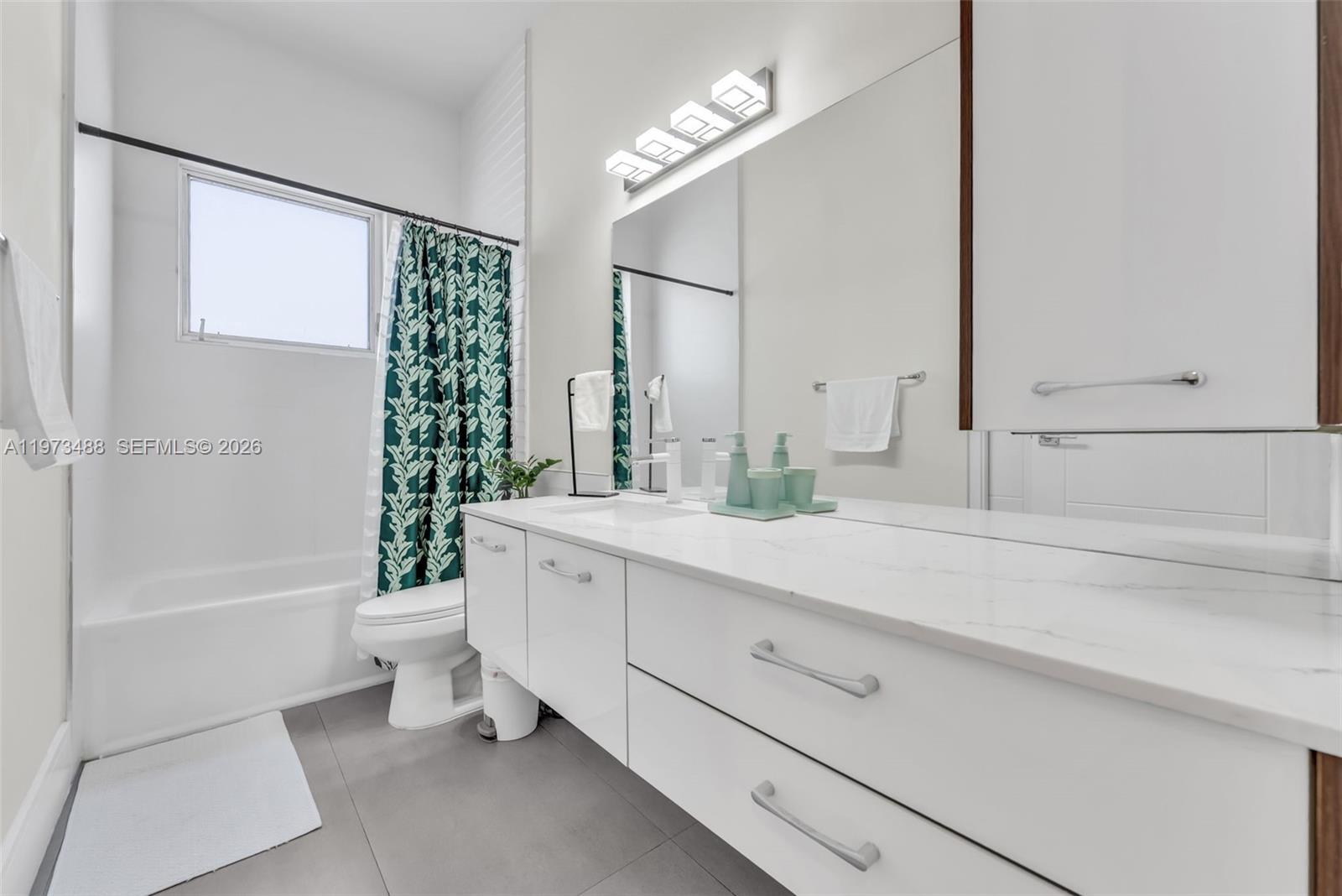 3055 Carter Street, Unit 3055 Miami, FL 33133 - Photo 18 of 32 a bathroom with a sink a toilet and bathtub