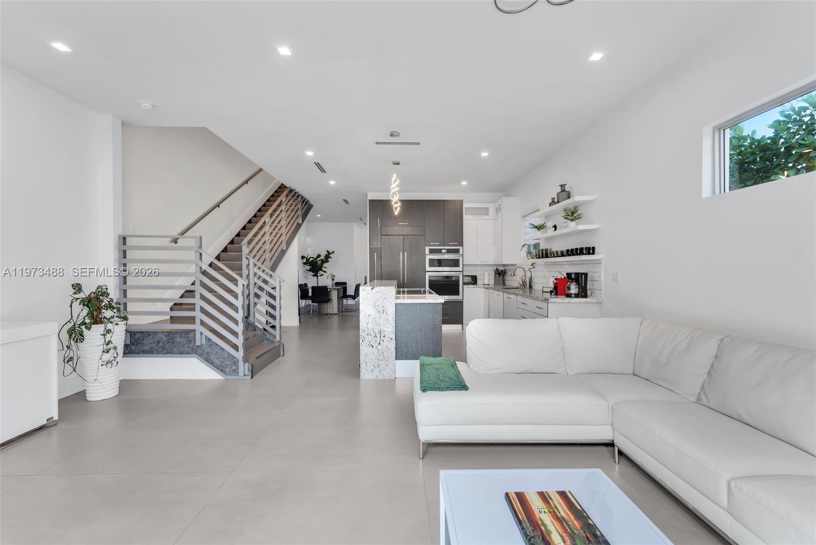 3055 Carter Street, Unit 3055 Miami, FL 33133 - Photo 2 of 32 a living room with furniture and stairs