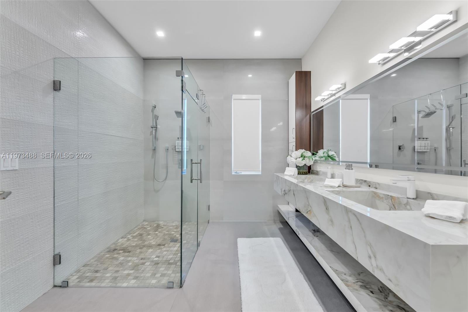 3055 Carter Street, Unit 3055 Miami, FL 33133 - Photo 22 of 32 a bathroom with a double vanity sink mirror and shower