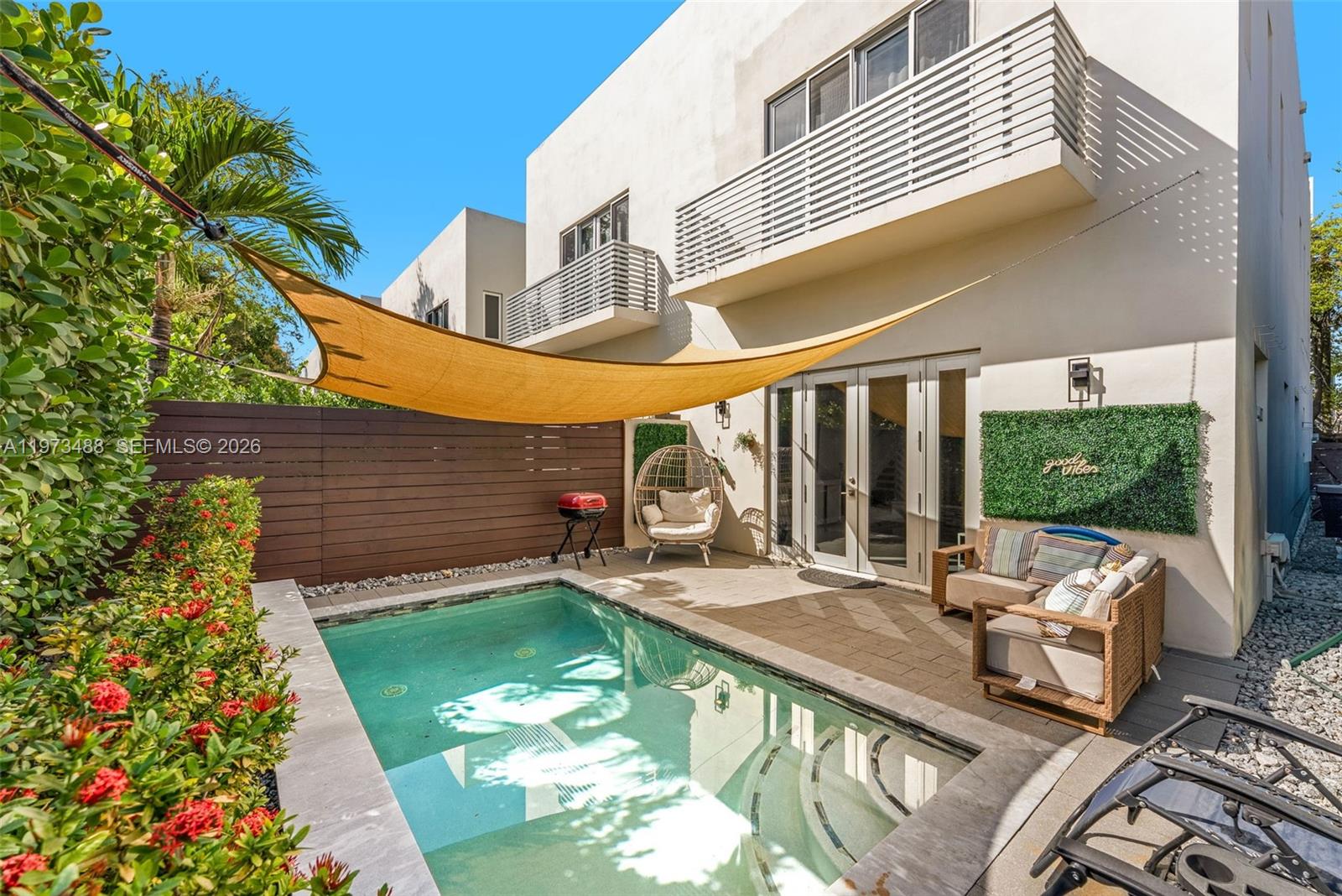 3055 Carter Street, Unit 3055 Miami, FL 33133 - Photo 27 of 32 a view of a patio with table and chairs potted plants with wooden floor