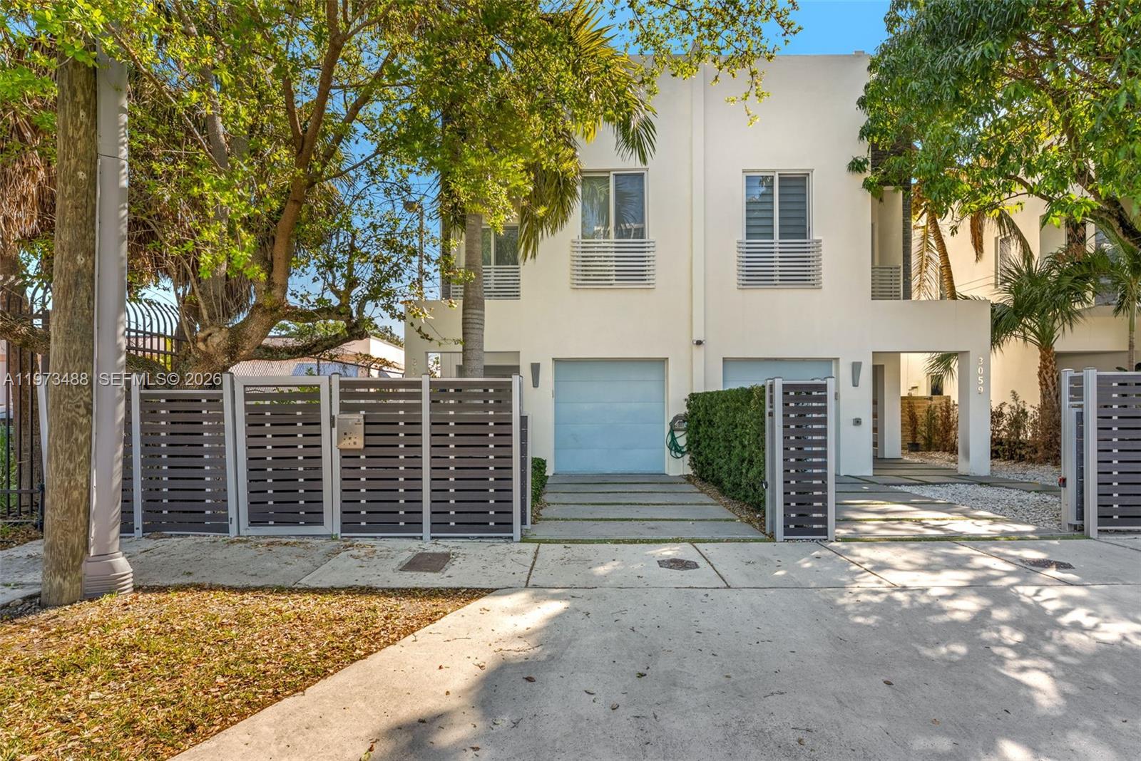 3055 Carter Street, Unit 3055 Miami, FL 33133 - Photo 28 of 32 front view of a house with a large tree