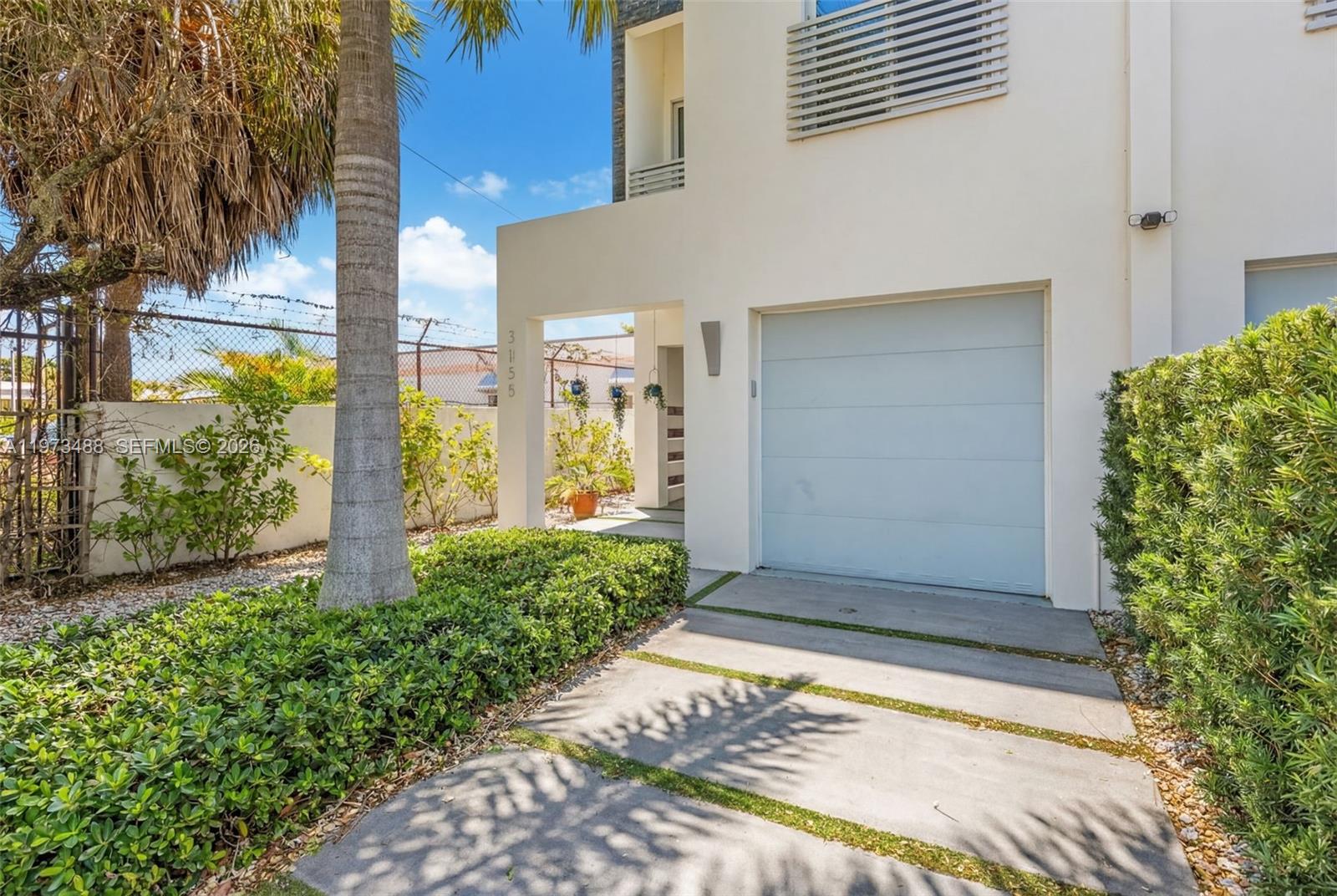 3055 Carter Street, Unit 3055 Miami, FL 33133 - Photo 29 of 32 a front view of a house with a yard