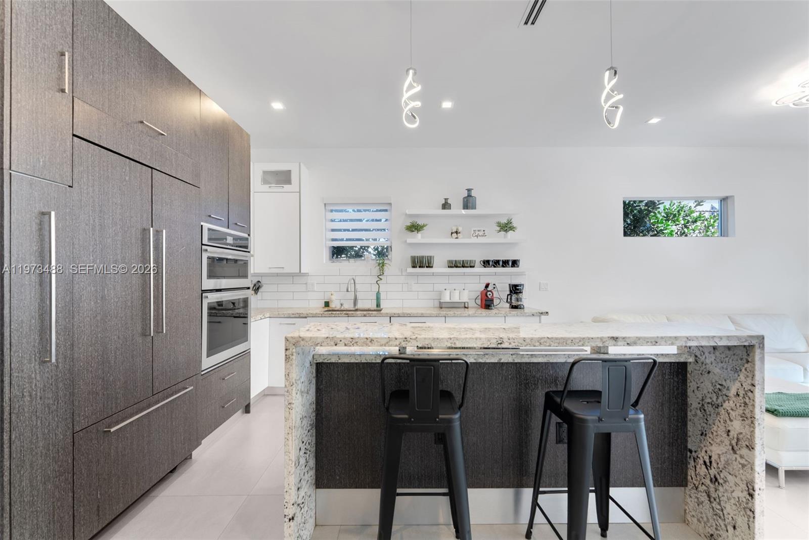 3055 Carter Street, Unit 3055 Miami, FL 33133 - Photo 4 of 32 a kitchen with granite countertop cabinets and stainless steel appliances