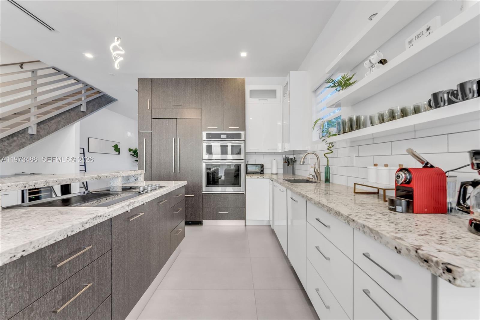 3055 Carter Street, Unit 3055 Miami, FL 33133 - Photo 5 of 32 a large kitchen with stainless steel appliances kitchen island granite countertop a sink and cabinets
