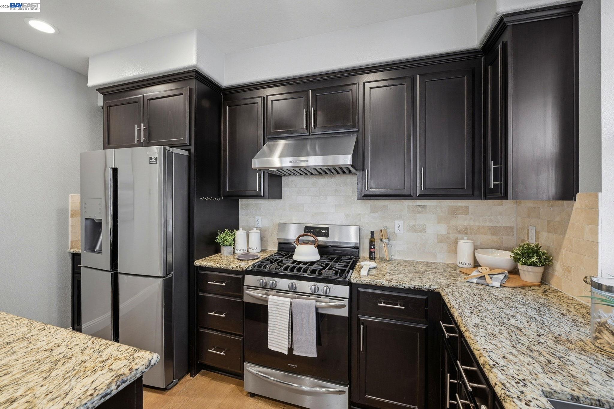 287 Wild Rose Way Milpitas, CA 95035 - Photo 11 of 45 a kitchen with stainless steel appliances granite countertop a refrigerator stove and sink