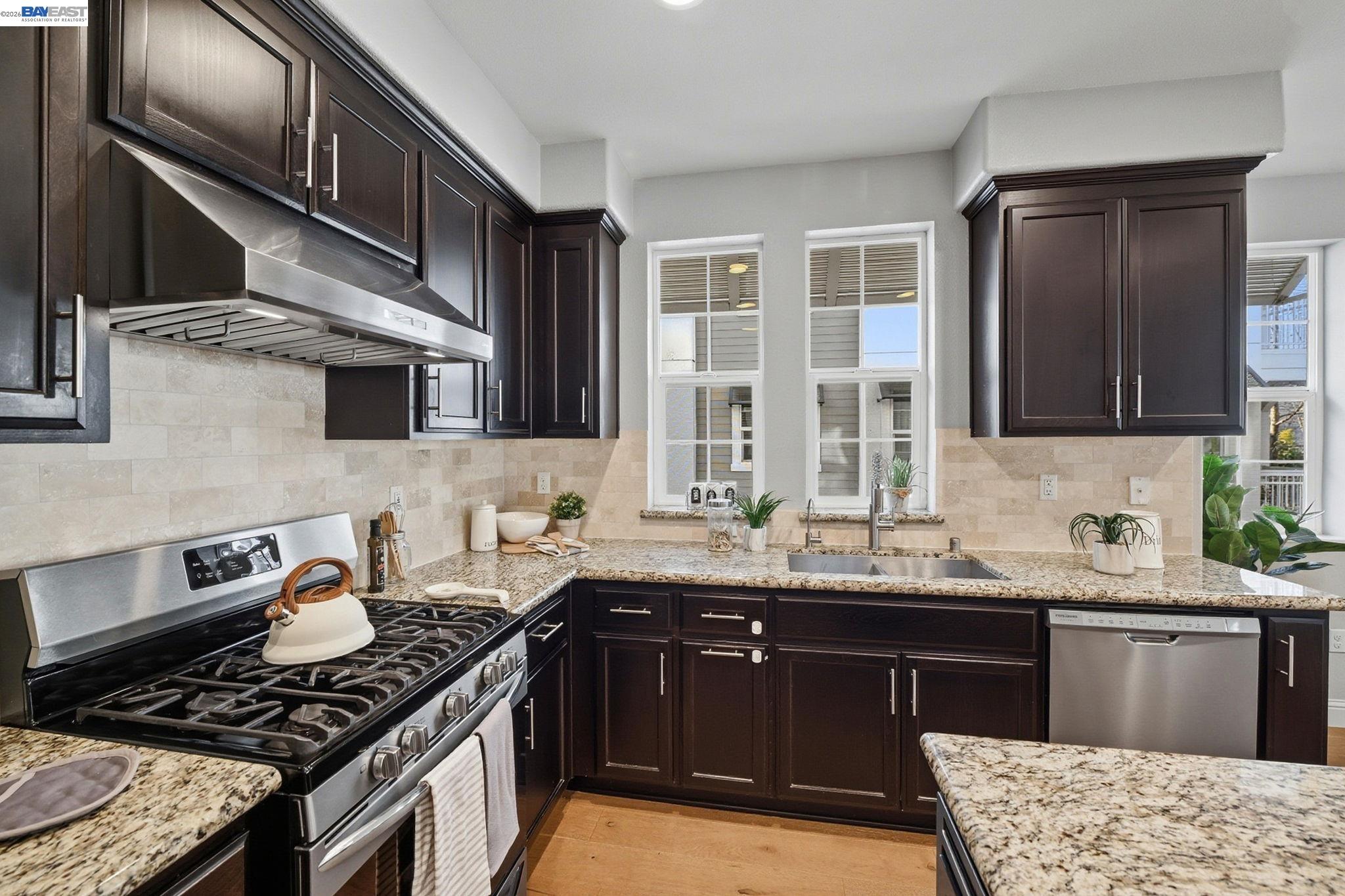287 Wild Rose Way Milpitas, CA 95035 - Photo 14 of 45 a kitchen with stainless steel appliances granite countertop a stove a sink and a microwave